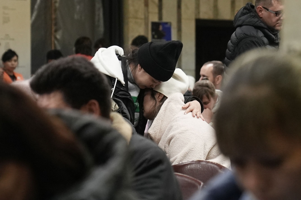 Relatives of miners sit at the Kostyenko ArcelorMittal coal mine building as a rescue operation continues following a mine fire in Karaganda, north-western Kazakhstan, on October 28, 2023. (Photo by Stringer / AFP)
