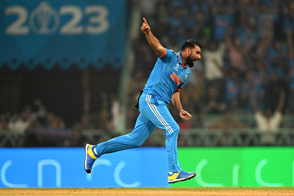 India's Mohammed Shami celebrates with teammates after taking the wicket of England's Jonny Bairstow during the 2023 ICC Men's Cricket World Cup one-day international (ODI) match between India and England at the Ekana Cricket Stadium in Lucknow on October 29, 2023. Photo by Sajjad Hussain / AFP