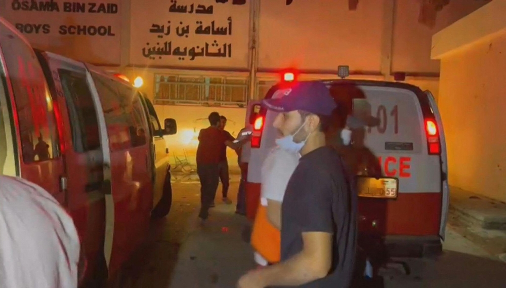 This image grab taken from an AFPTV video footage shows Palestinian medics at the Osama bin Zaid school, which shelters displaced people in the Saftawi area, north of Gaza City after a strike on November 3, 2023. (Photo by various sources / AFP)
