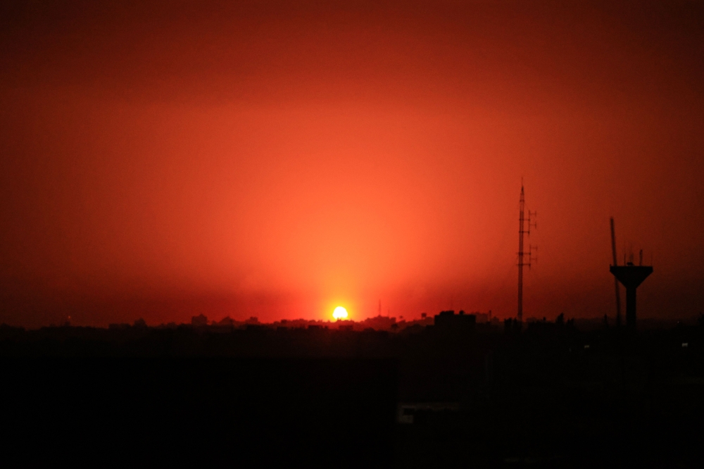An Israeli air strike lights the sky above Khan Yunis in the southern Gaza Strip on December 2, 2023. (Photo by Said Khatib / AFP)
