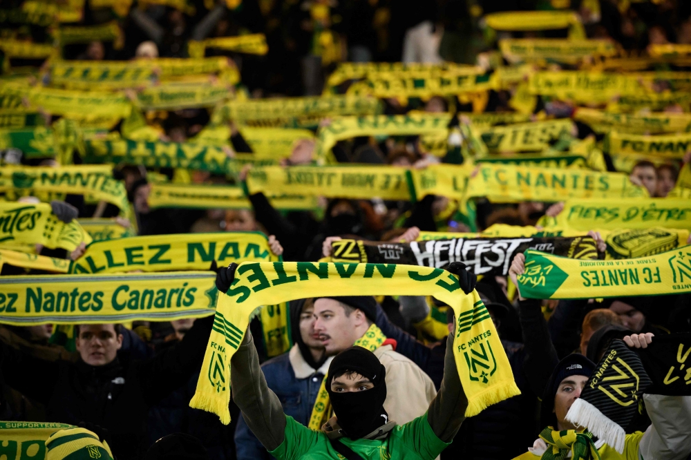 Nantes' supporters cheer their team during the French L1 football match between FC Nantes and OGC Nice at La Beaujoire stadium in Nantes, western France on December 2, 2023. (Photo by LOIC VENANCE / AFP)