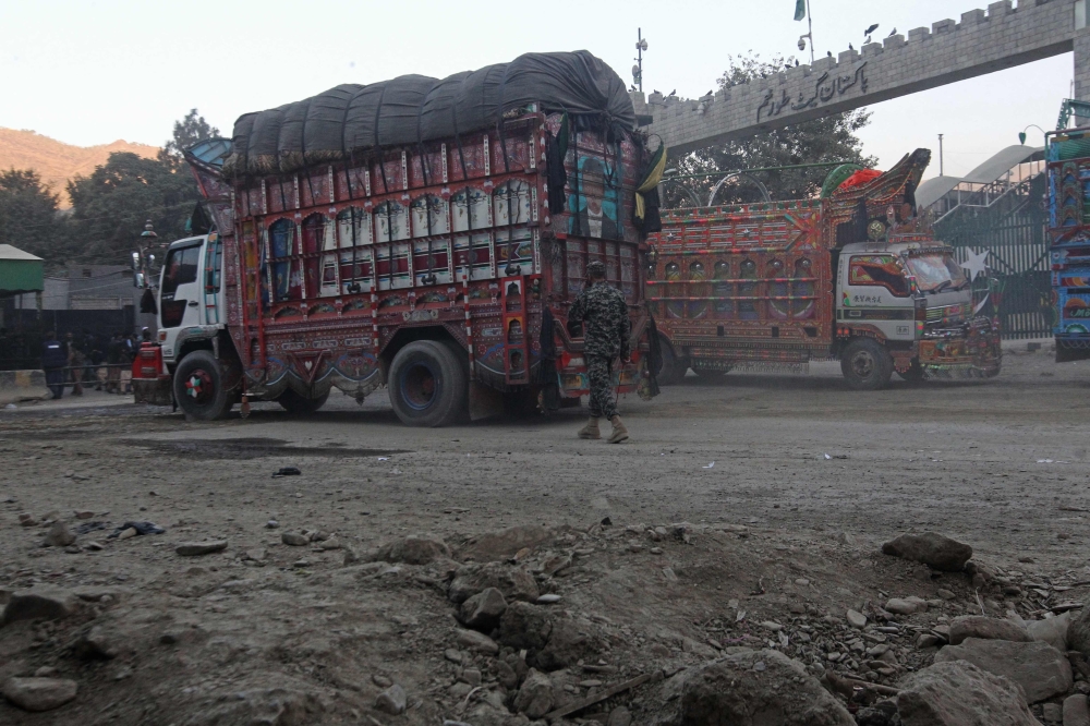 Trucks are pictured at the zero point Torkham border crossing between Afghanistan and Pakistan, in Nangarhar province on December 6, 2023. (Photo by Shafiullah Kakar / AFP)