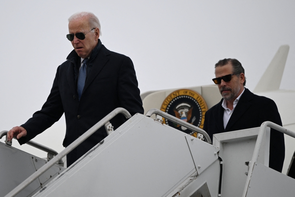 File: US President Joe Biden, with son Hunter Biden, arrives at Hancock Field Air National Guard Base in Syracuse, New York, on February 4, 2023. (Photo by Andrew Caballero-Reynolds / AFP)