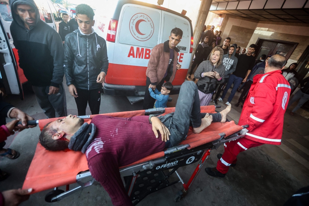 Palestinians react as the injured are brought to Nasser hospital in Khan Yunis in the southern Gaza Strip following Israeli bombardment on December 15, 2023. Photo by AFP