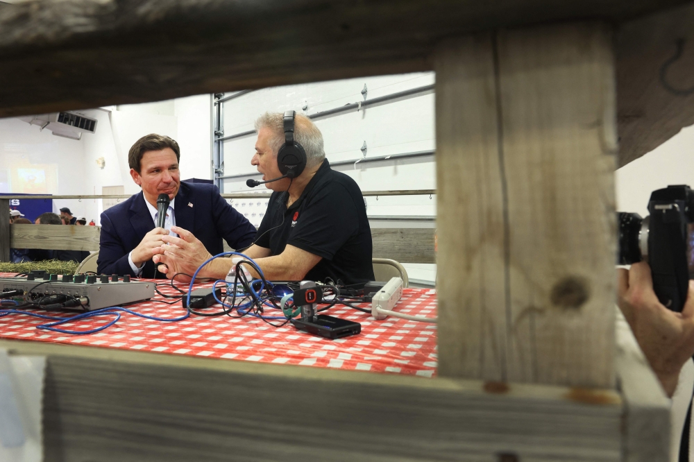 Republican presidential candidate Florida Governor Ron DeSantis gives a radio interview at Ashley's BBQ Bash hosted by Congresswoman Ashley Hinson (R-IA) on August 06, 2023 in Cedar Rapids, Iowa. (Photo by SCOTT OLSON / GETTY IMAGES NORTH AMERICA / Getty Images via AFP)