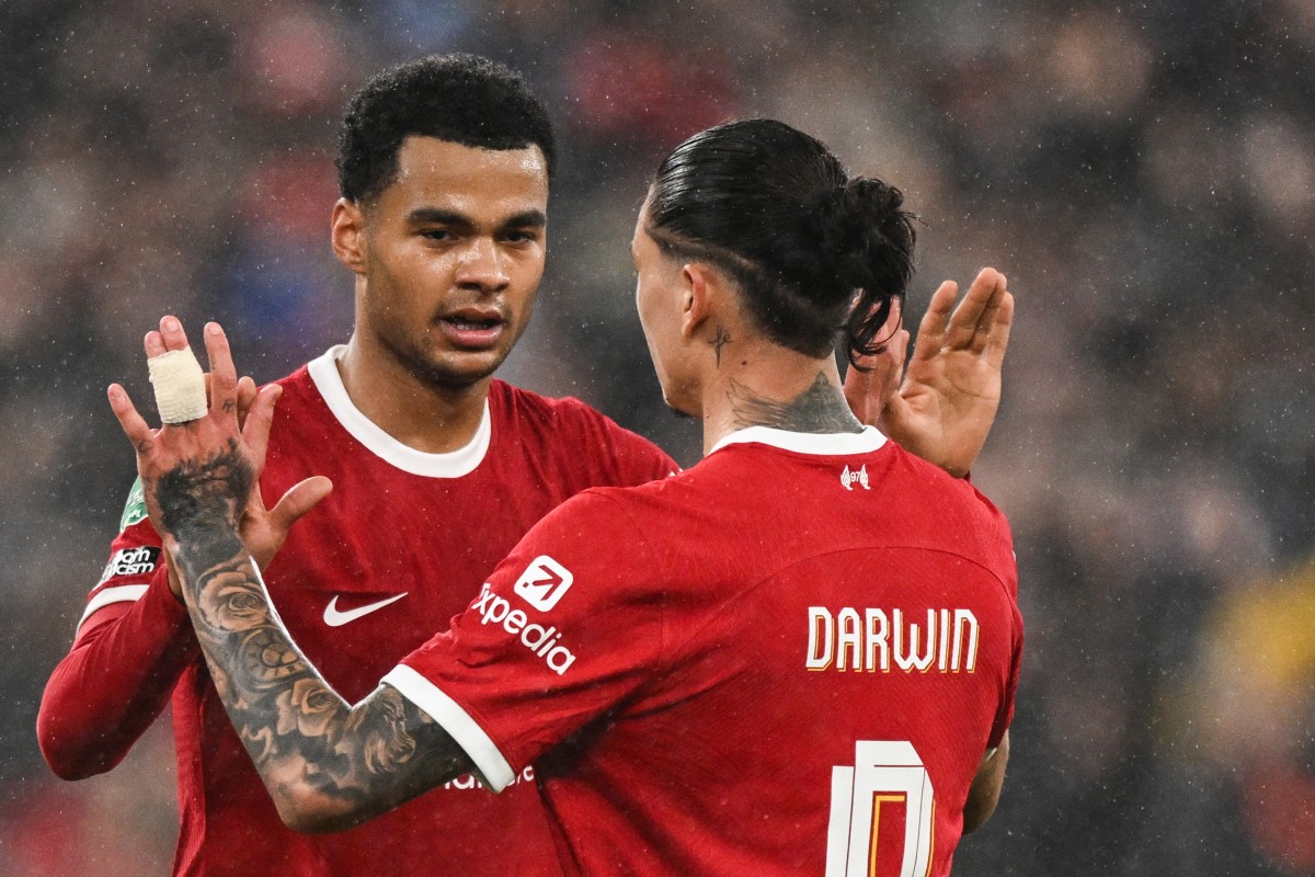 Liverpool's Dutch striker #18 Cody Gakpo (L) celebrates with Liverpool's Uruguayan striker #09 Darwin Nunez after scoring his team third goal during the English League Cup quarter-final football match between Liverpool and West Ham United at Anfield in Liverpool, north west England on December 20, 2023. (Photo by Oli SCARFF / AFP)