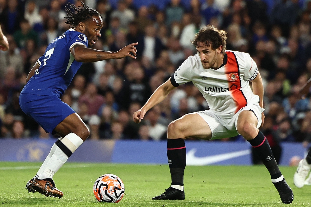 (FILES) Chelsea's English midfielder #07 Raheem Sterling (L) Luton Town's Welsh defender #04 Tom Lockyer (R) during the English Premier League football match between Chelsea and Luton at Stamford Bridge in London on August 25, 2023. (Photo by HENRY NICHOLLS / AFP)