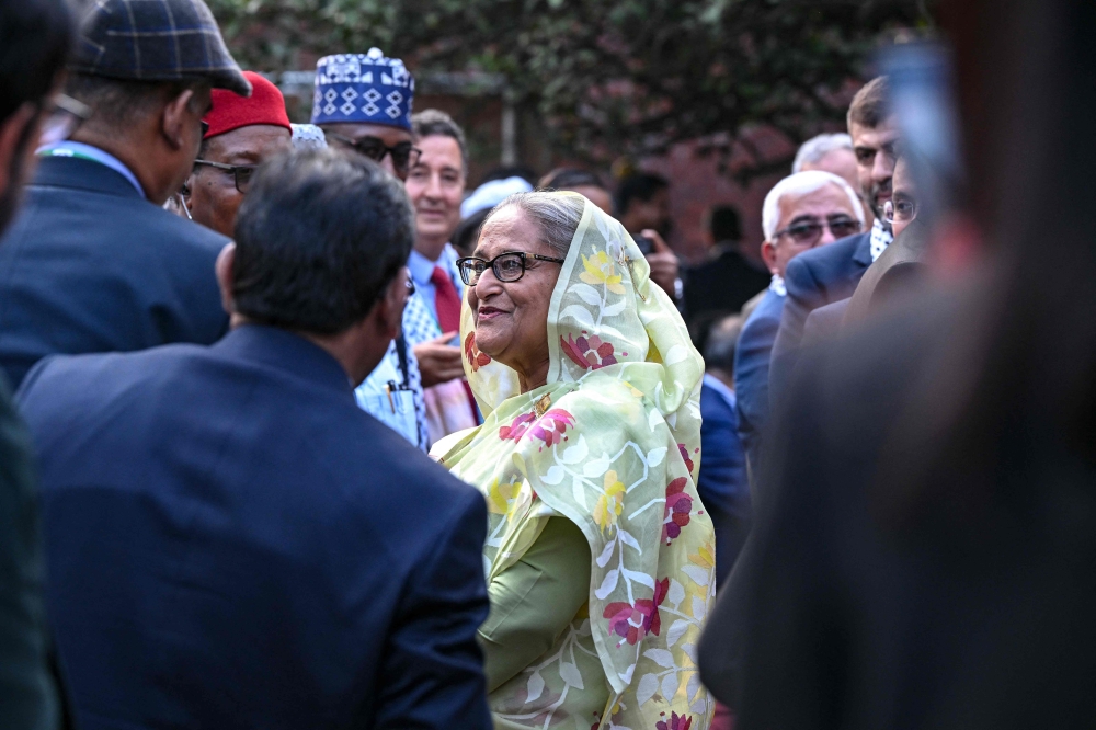 Bangladesh's Prime Minister Sheikh Hasina accepts the greetings from the assembled media and election observers while addressing a press conference, a day after she won the 12th parliamentary elections, in Dhaka on January 8, 2024. (Photo by INDRANIL MUKHERJEE / AFP)
