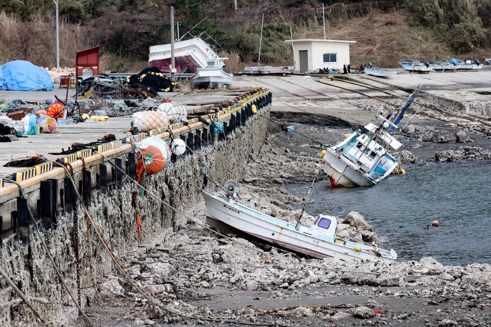 This photograph provided by Jiji Press and taken on January 12, 2024 shows the exposed ocean floor at Kaiso Port in Wajima city, Ishikawa prefecture in the after a 7.5 magnitude earthquake struck the Noto region in Ishikawa prefecture on New Year's Day. (Photo by JIJI PRESS / AFP) / Japan OUT
