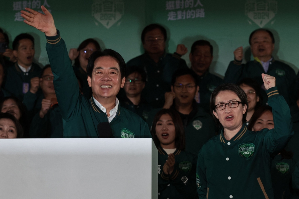 Taiwan's President-elect Lai Ching-te (L) waves beside his running mate Hsiao Bi-khim during a rally outside the headquarters of the Democratic Progressive Party (DPP) in Taipei on January 13, 2024. (Photo by Yasuyoshi Chiba / AFP)
 
