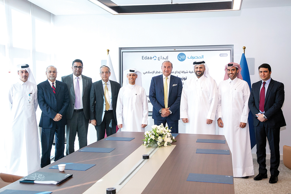 Representatives from QIB and Edaa during the agreement signing ceremony.