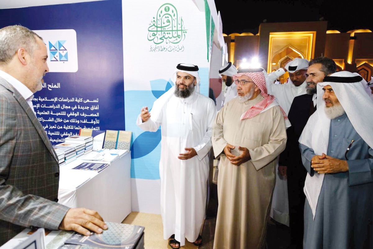 Minister of Awqaf and Islamic Affairs H E Ghanem bin Shaheen Al Ghanem (second right) with Director of General Endowment Department Dr. Sheikh Khalid bin Mohammed bin Ghanem Al Thani (third right) and other officials touring an associated exhibition during First Endowment Forum at the premises of Imam Muhammad bin Abdul Wahhab Mosque.