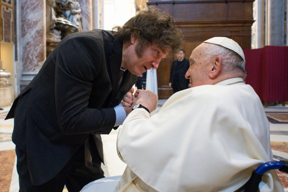 This handout photograph taken on February 11, 2024 and released by the Vatican press office, Vatican Media, shows Pope Francis (R) greeting Argentine President Javier Milei (L) at the Vatican. (Photo by Handout / VATICAN MEDIA / AFP)
