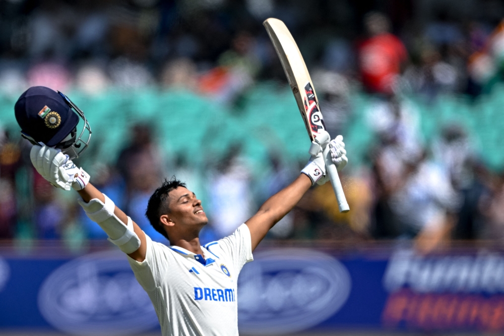 India's Yashasvi Jaiswal celebrates after scoring a double century (200 runs) during the fourth day of the third Test cricket match between India and England at the Niranjan Shah Stadium in Rajkot on February 18, 2024. (Photo by Punit Paranjpe / AFP) 