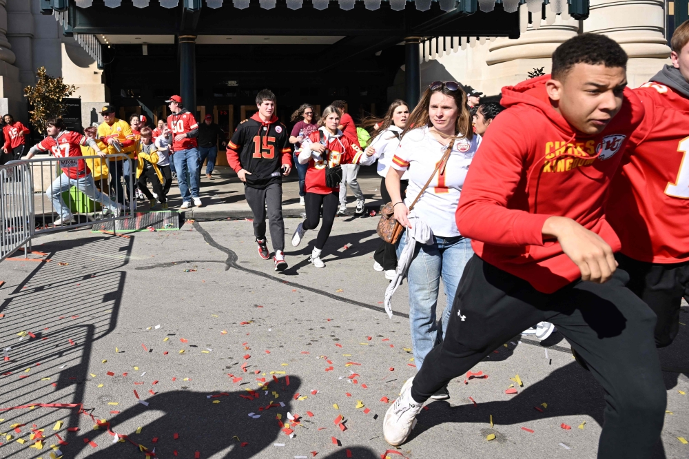 People flee after shots were fired near the Kansas City Chiefs' Super Bowl LVIII victory parade on February 14, 2024, in Kansas City, Missouri. (Photo by ANDREW CABALLERO-REYNOLDS / AFP)


