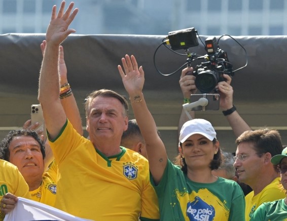 Former Brazilian President Jair Bolsonaro greets supporters next to his wife Michelle Bolsonaro during a rally in Sao Paulo, Brazil, on February 25, 2024, to reject claims he plotted a coup with allies to remain in power after his failed 2022 reelection bid. (Photo by Nelson Almeida / AFP)