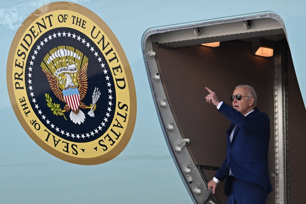 US President Joe Biden gestures as he arrives at John F. Kennedy International Airport, in Queens, New York on February 26, 2024. (Photo by Jim WATSON / AFP)
