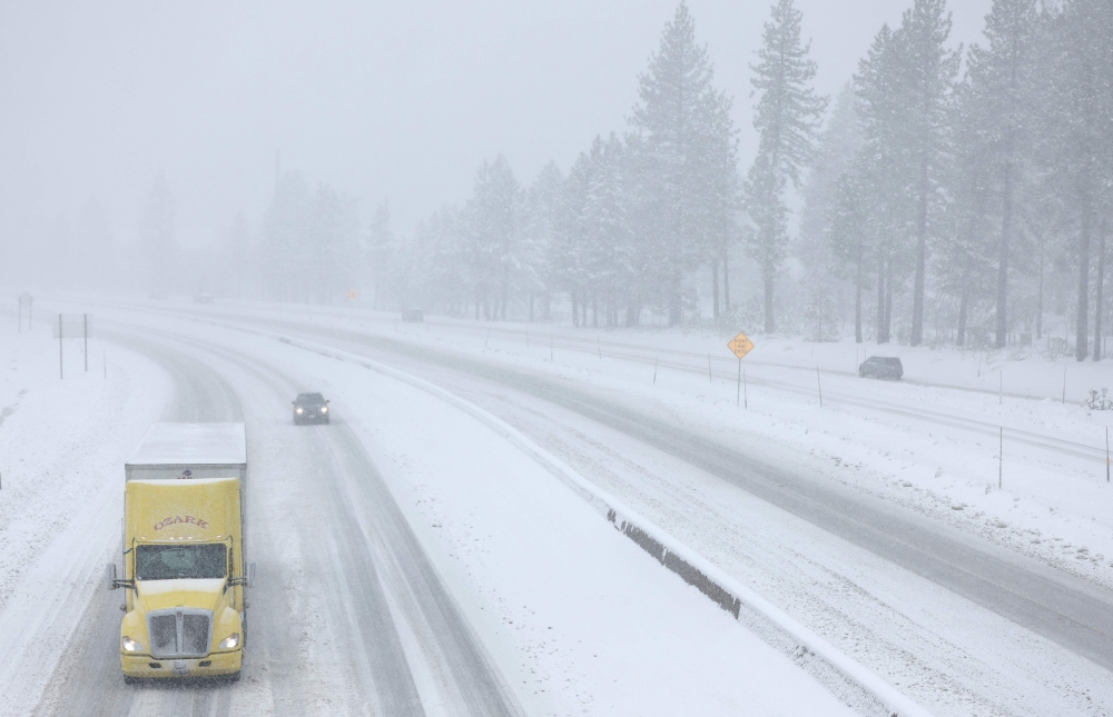 Vehicles drive on I-80 as Snow falls north of Lake Tahoe in the Sierra Nevada mountains during a powerful winter storm on March 01, 2024 in Truckee, California. Mario Tama/Getty Images/AFP 