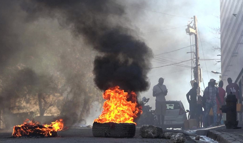 This screen grab taken from AFPTV shows tires on fire near the main prison of Port-au-Prince, Haiti, on March 3, 2024, after a breakout by several thousand inmates. (Photo by Luckenson Jean / AFPTV / AFP)
