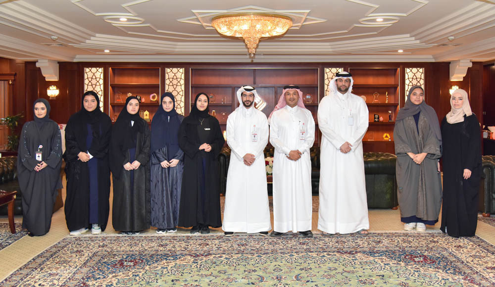 QIIB’s Head of Human Resources and Administrative Affairs, Ali Hamad Al Mesaifri; QIIB’s Head of Business Development, Khaled Abdul Rahman Al Shaibei pose for a group photo with students.