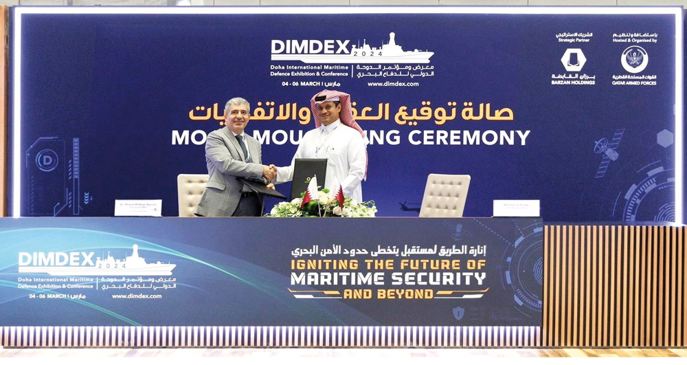 CEO of Barzan Holdings Abdullah Hassan Al Khater (right) and UBKU President Dr. Ahmad M. Hasnah exchange documents after signing the MoU.