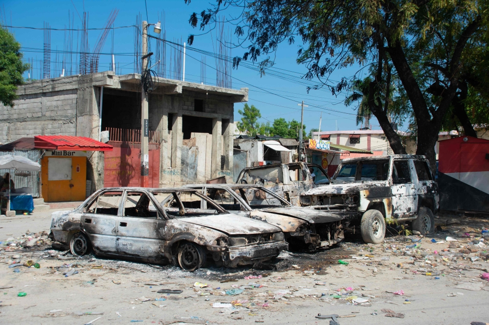 Charred vehicles remain parked as gang violence escalates in Port-au-Prince, Haiti, on March 9, 2024. (Photo by Clarens SIFFROY / AFP)
