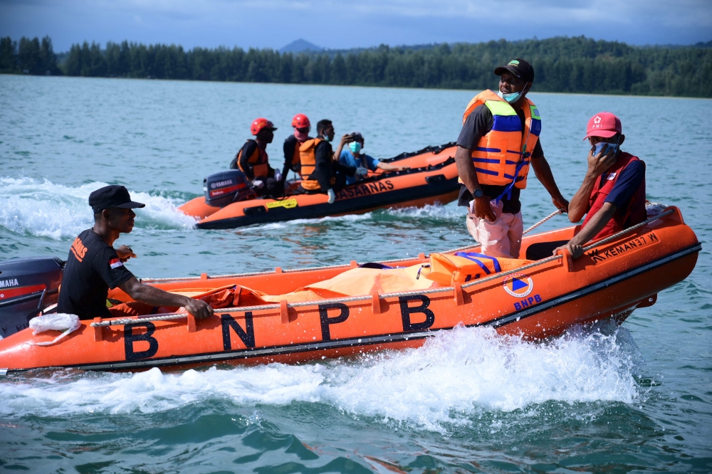 Members of the National Search and Rescue Agency (BASARNAS) search for missing Rohingya refugees after 69 refugees were rescued from their overturned boat in the sea near Calang, West Aceh, on March 23, 2024. (Photo by Zahlul AKBAR / AFP)
