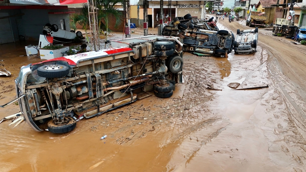 This handout picture released by the Espirito Santo State Government shows vehicles overturned on a street covered by mud after heavy rains hit the southeastern region of Brazil on March 24, 2024, in Mimoso do Sul, Espirito Santo State. (Photo by Wender / ESPIRITO SANTO STATE GOVERNMENT / AFP)