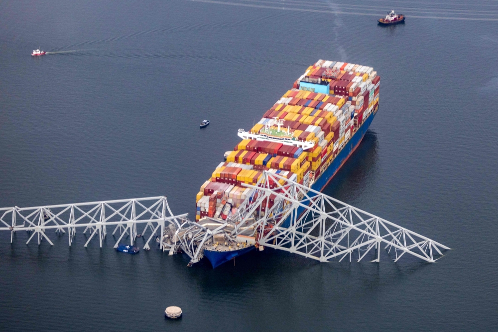 BALTIMORE, MARYLAND - MARCH 26: In an aerial view, cargo ship Dali is seen after running into and collapsing the Francis Scott Key Bridge on March 26, 2024 in Baltimore, Maryland. Photo by TASOS KATOPODIS / GETTY IMAGES NORTH AMERICA / Getty Images via AFP.