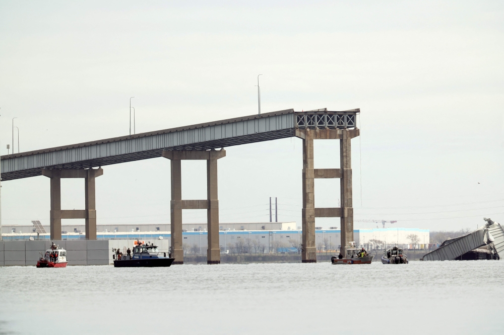 One remaining end of the Francis Scott Key Bridge stands in the water after the bridge collapsed when the cargo ship Dali ran into and collapsed it on March 26, 2024 in Baltimore, Maryland. (Photo by Kevin Dietsch / GETTY IMAGES NORTH AMERICA / Getty Images via AFP)
