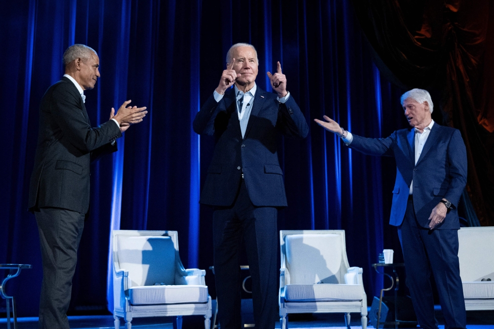 Former US President Barack Obama (left) and former US President Bill Clinton (right) cheer for US President Joe Biden during a campaign fundraising event at Radio City Music Hall in New York City on March 28, 2024. (Photo by Brendan Smialowski / AFP)