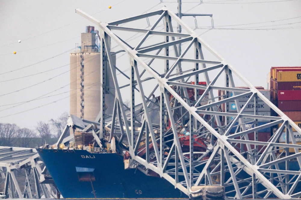 Wreckage from the collapsed Francis Scott Key Bridge rests on the Dali cargo ship as efforts begin to clear the debris and reopen the Port of Baltimore on March 31, 2024, in Baltimore, Maryland. (Photo by TASOS KATOPODIS / GETTY IMAGES NORTH AMERICA / Getty Images via AFP)

