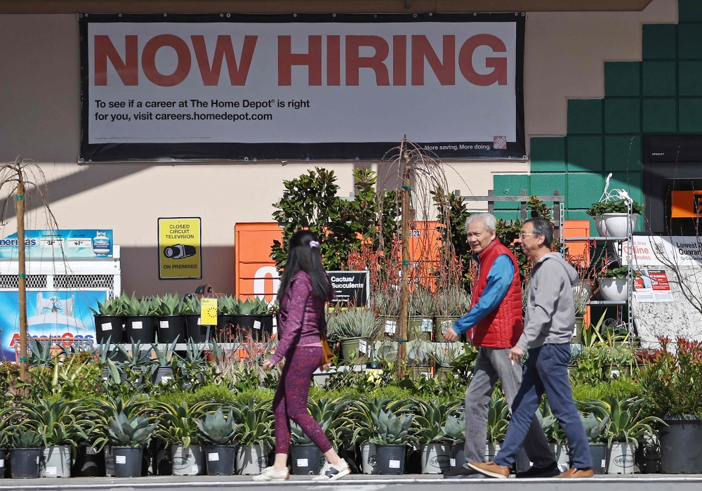 (FILES) Home Depot customers walk by a posted now hiring sign on March 8, 2024 in San Rafael, California. (Photo by JUSTIN SULLIVAN / GETTY IMAGES NORTH AMERICA / AFP)
