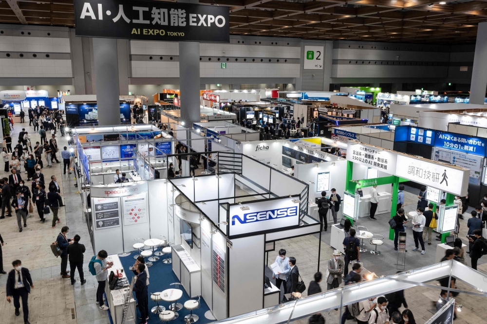 This file photo taken on May 10, 2023 shows a general view of exhibitors at various booths during the three-day 7th AI Expo, part of NexTech Week Tokyo 2023, Japan's largest trade show for artificial intelligence technology companies, at Tokyo Big Sight. Photo by Richard A. Brooks / AFP
