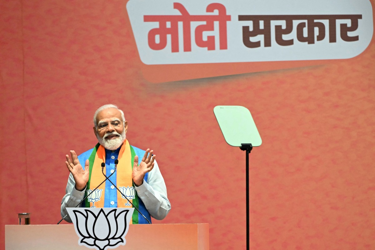India's Prime Minister Narendra Modi speaks after releasing the Bharatiya Janata Party's (BJP) manifesto ahead of country's upcoming general elections, at the party headquarters in New Delhi on April 14, 2024. (Photo by Sajjad HUSSAIN / AFP)