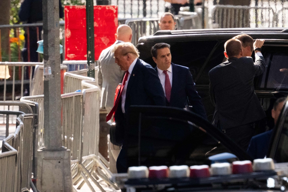 Former US President Donald Trump arrives at Manhattan Criminal Court as he attends the first day of his trial for allegedly covering up hush money payments linked to extramarital affairs, in New York City on April 15, 2024. Photo by Adam GRAY / AFP.