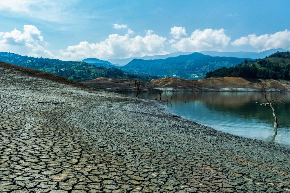 View showing the low water level of the Guavio reservoir that feeds the Guavio Hydroelectric Power Plant in Gachala, Cundinamarca Department, Colombia, on April 16, 2024. (Photo by Jhojan Hilarion / AFP)