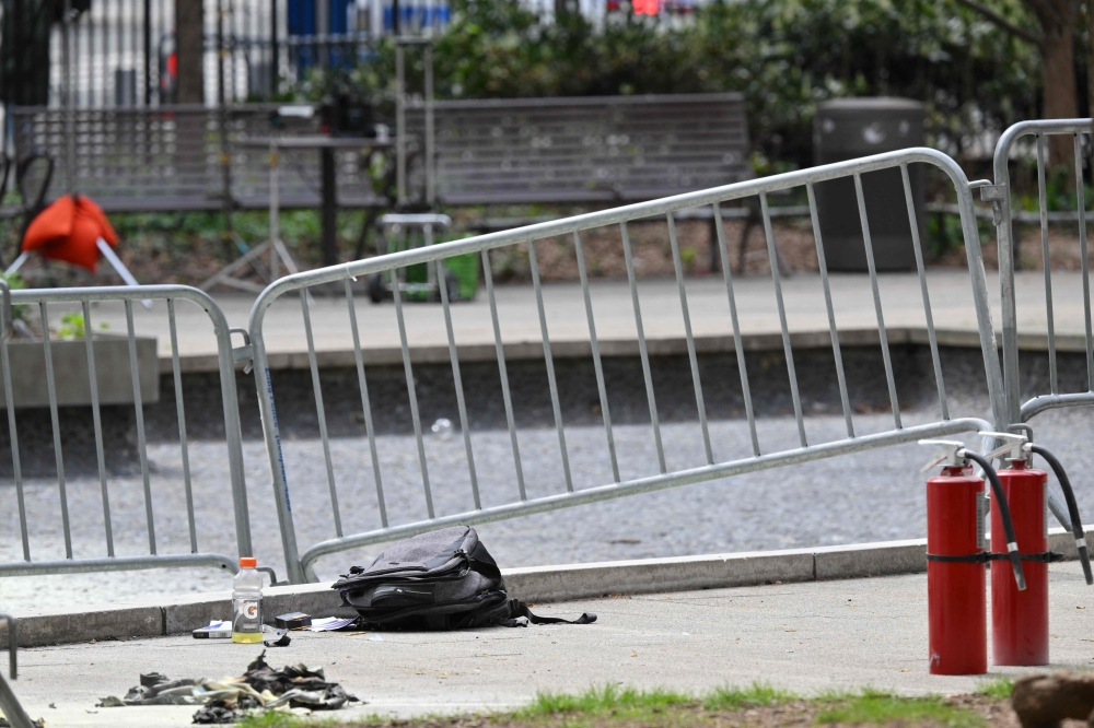 Fire extinguishers are left at the park across from Manhattan Criminal Court in New York City after a man reportedly set himself on fire during the trial of US President Donald Trump, in New York City on April 19, 2024. (Photo by Angela Weiss / AFP)
