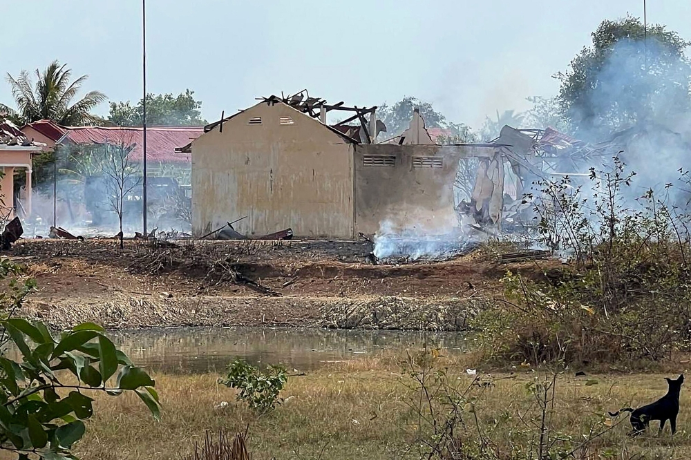Smoke billows from the warehouse following an explosion at an army base in Kampong Speu province on April 27, 2024. (Photo by AFP)
