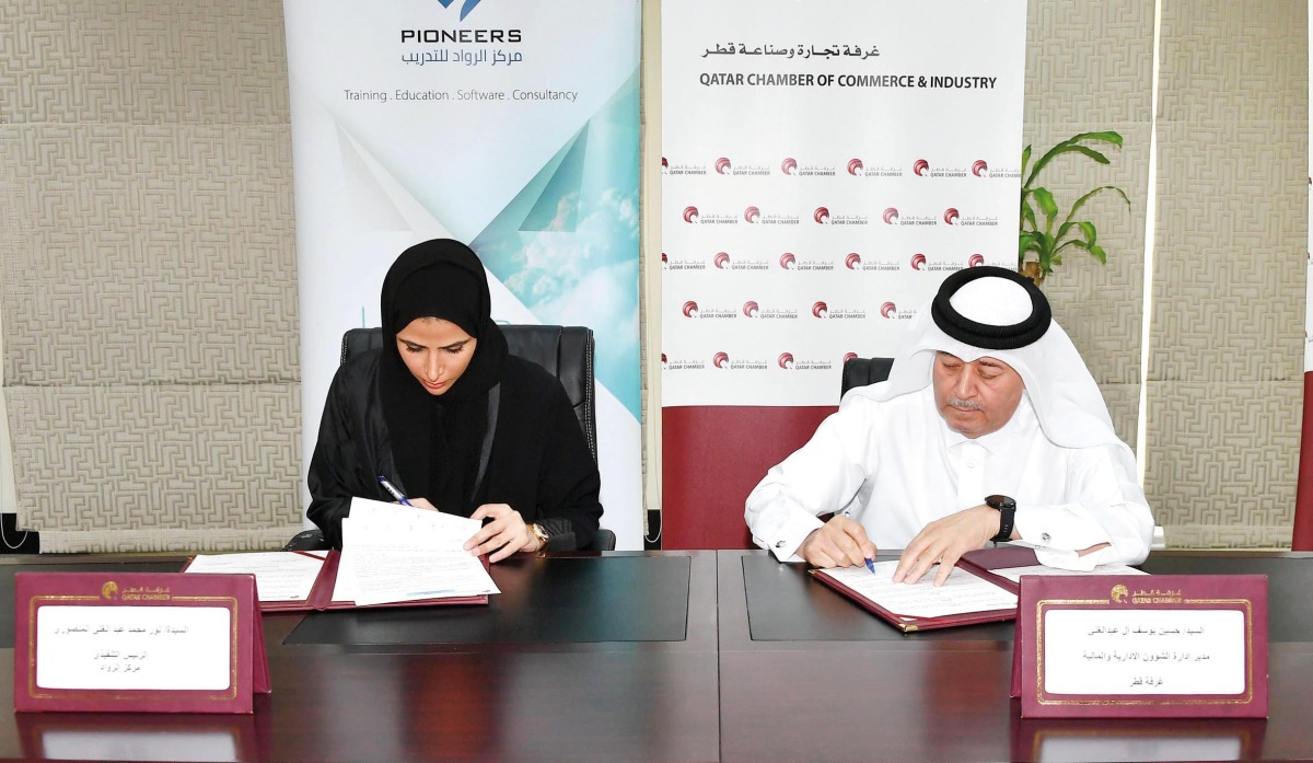 QC Director of Administrative and Finance Department, Hussain Yousef Al Abdullghani, and CEO of Pioneers Training Centre, Noor Mohamed Al Mansoori, signing the agreement.