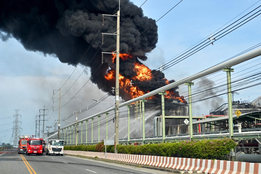 Firefighters work to extinguish a fire in a gas storage tank at the Maptaphut Industrial Port in Rayong province, eastern Thailand, on May 9, 2024. (Photo by James Wilson / Thai News Pix / AFP)
 
