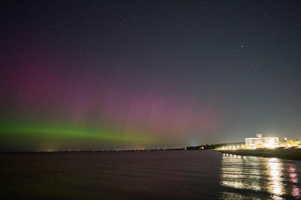 The Northern lights or aurora borealis illuminate the night sky in Grand Bend, Ontario, Canada, during a geomagnetic storm on May 12, 2024. Photo by Geoff Robins / AFP