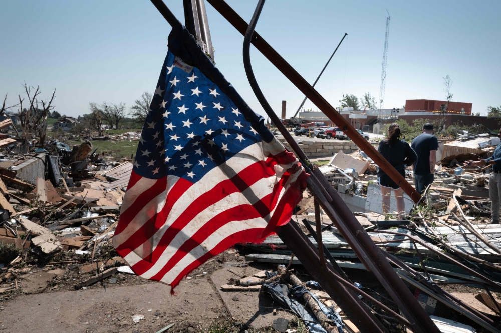 An American flag is see as residents go through the damage after a tornado tore through town yesterday afternoon on May 22, 2024 in Greenfield, Iowa. Photo by SCOTT OLSON / GETTY IMAGES NORTH AMERICA / Getty Images via AFP.

