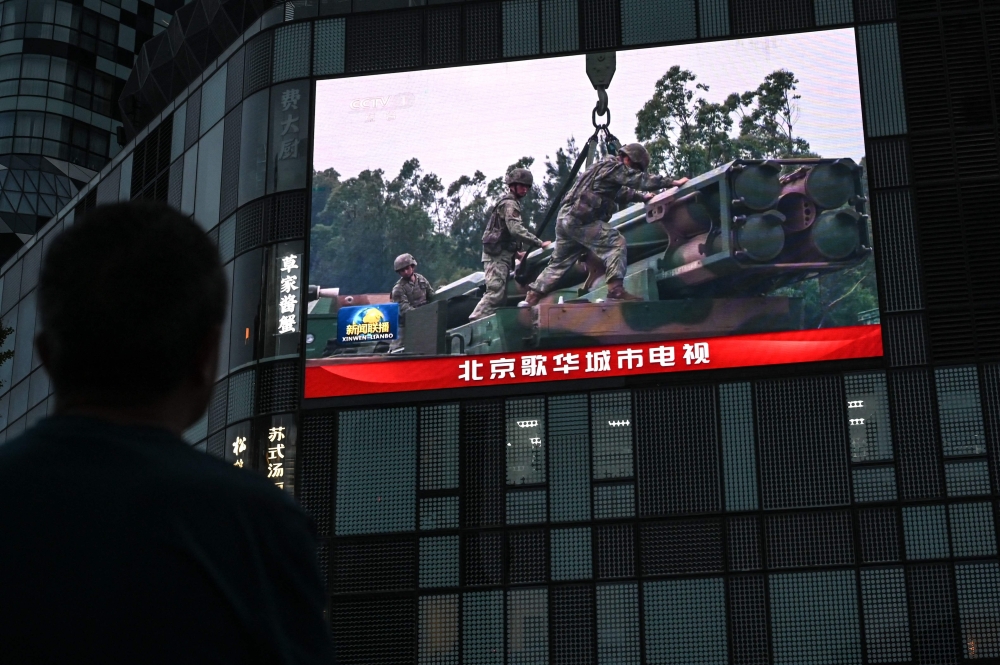 An outdoor screen shows a news coverage of China military drills around Taiwan, in Beijing on May 23, 2024. Photo by Jade Gao / AFP.