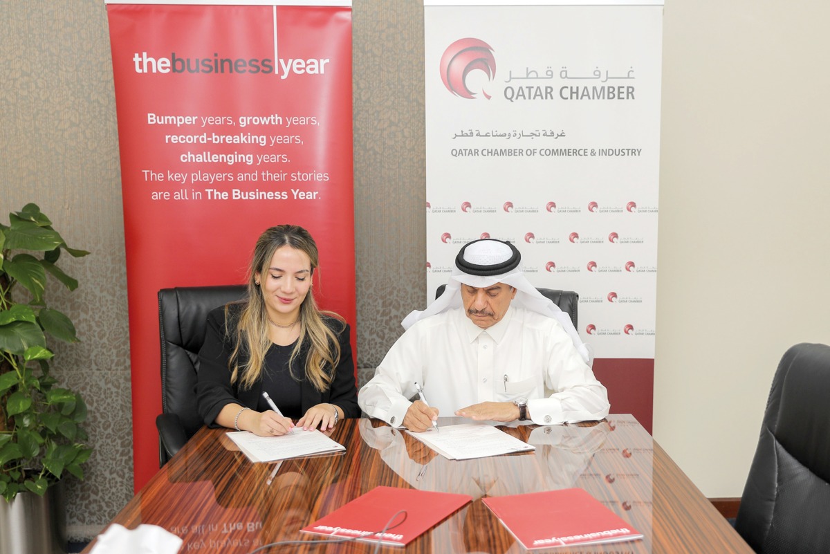 Ali Saeed Bu Sherbak Al Mansouri, Acting General Manager of Qatar Chamber, and Vanessa Rameix, Country Director for The Business Year in Qatar during the MoU signing.