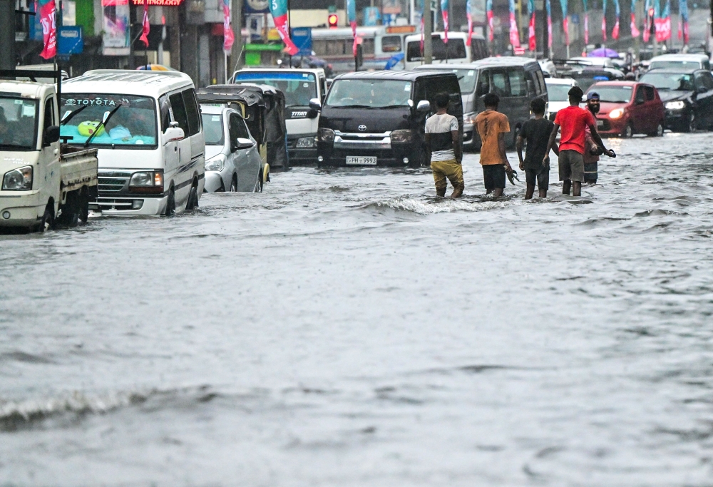 Motorists make their way through a flooded street after heavy rains in Colombo on June 2, 2024. Photo by Ishara S.Kodikara / AFP