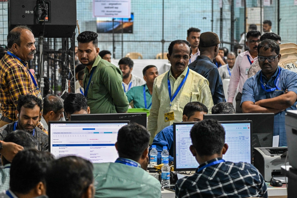Electoral officials work at an election vote counting station in Mumbai on June 4, 2024. (Photo by Punit Paranjpe / AFP)
 