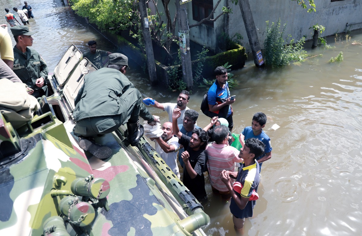  A soldier distributes food to people affected by the floods in Colombo, Sri Lanka, on June 4, 2024. (Photo by Ajith Perera/Xinhua)
 