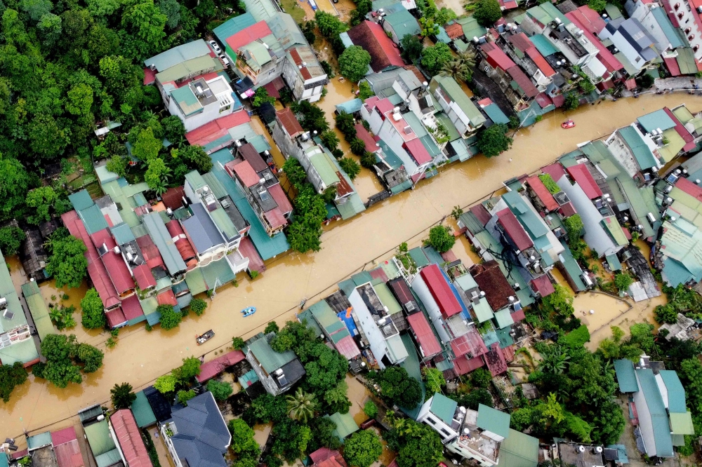 An aerial picture shows flood waters submerging buildings after heavy rain in Ha Giang city in northern Vietnam on June 10, 2024. Photo by Trong Hai / AFP