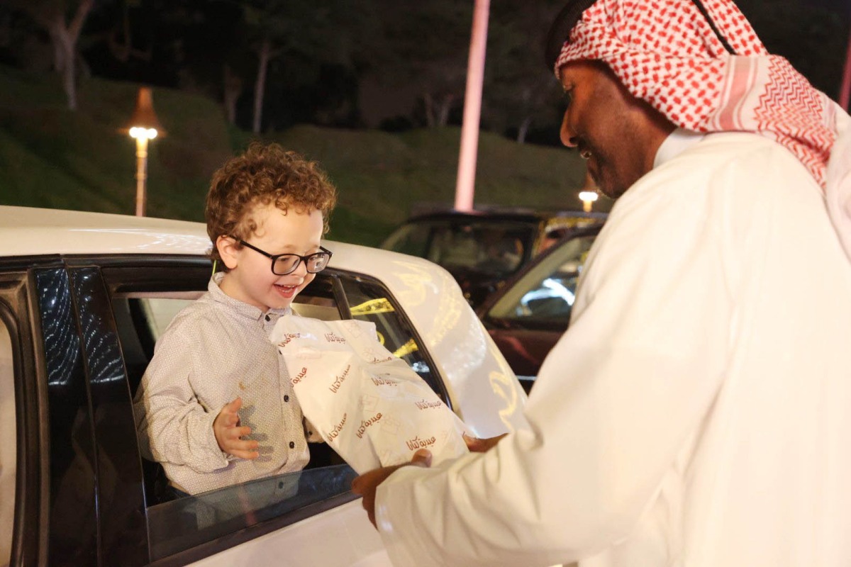 A kid receives a gift during the Eid celebration at the Katara Cultural Village yesterday.